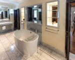 a bathroom with a tub and mirrors